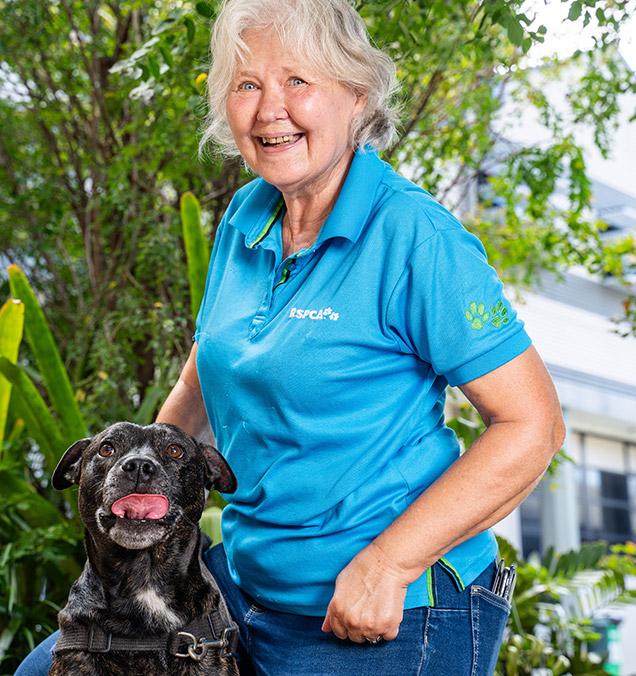 Volunteer Elsi with black dog.